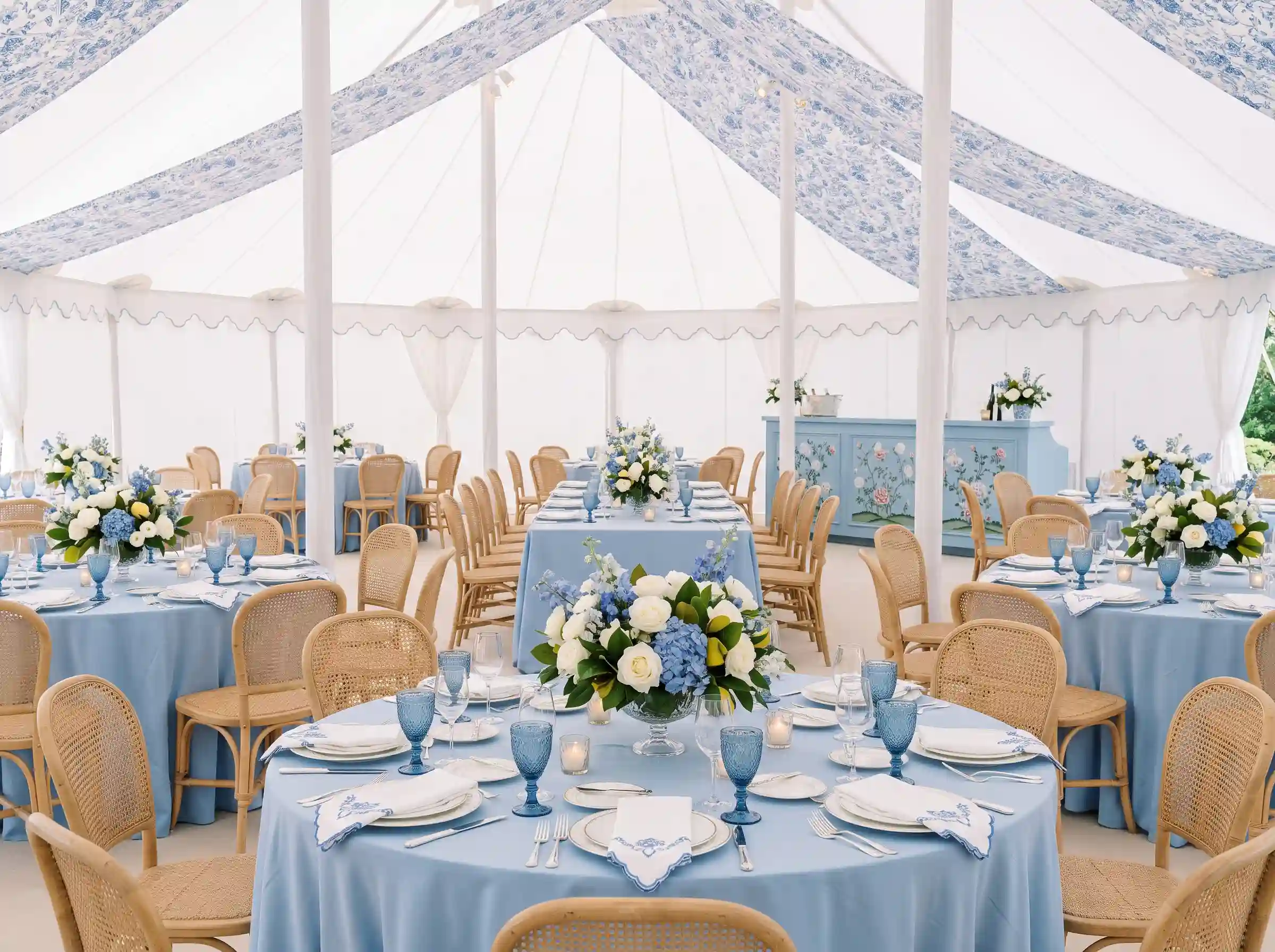 Blue porcelain pavilion dinner reception with hydrangeas and white pole tent with scalloped valances