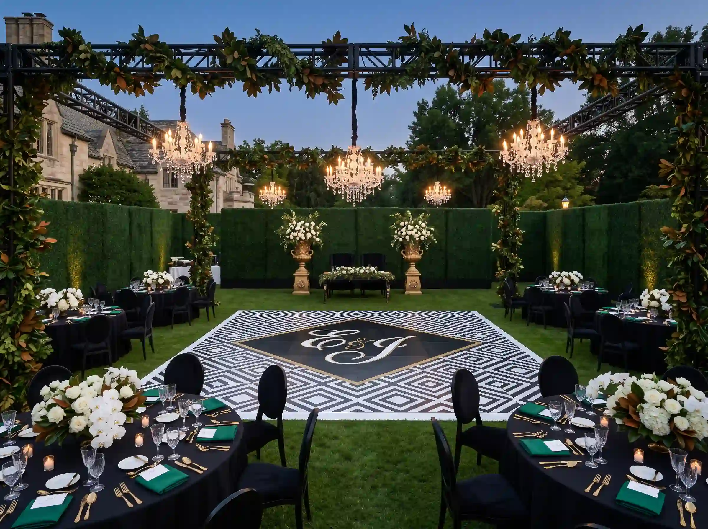 Formal estate lawn black tie wedding reception with crystal chandeliers and monogrammed dance floor