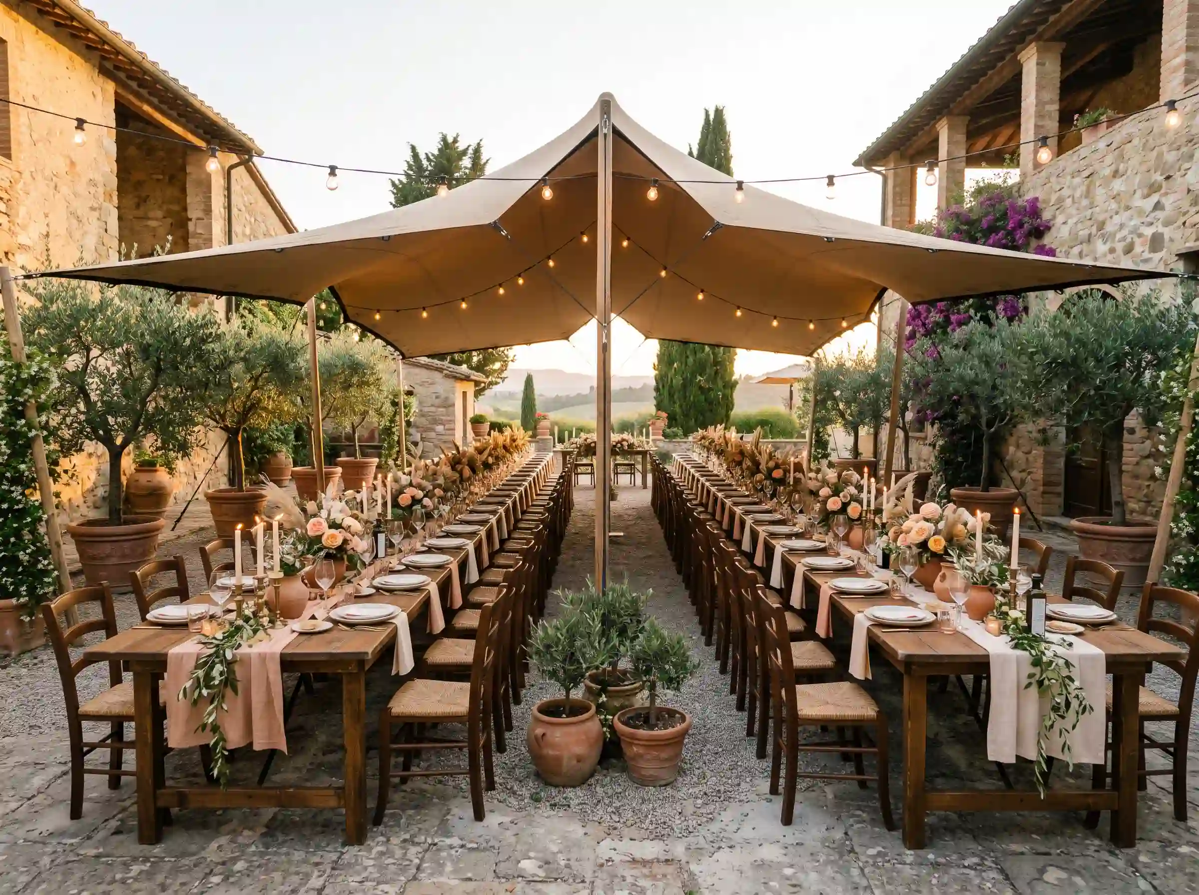 Terracotta Tuscan backyard feast with farmhouse tables and olive branches under a sand-colored stretch tent