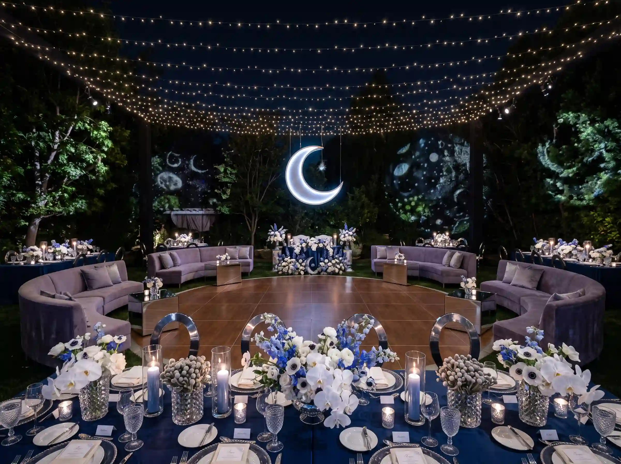 Celestial midnight wedding reception with suspended star lights crescent lounge seating and moon installation