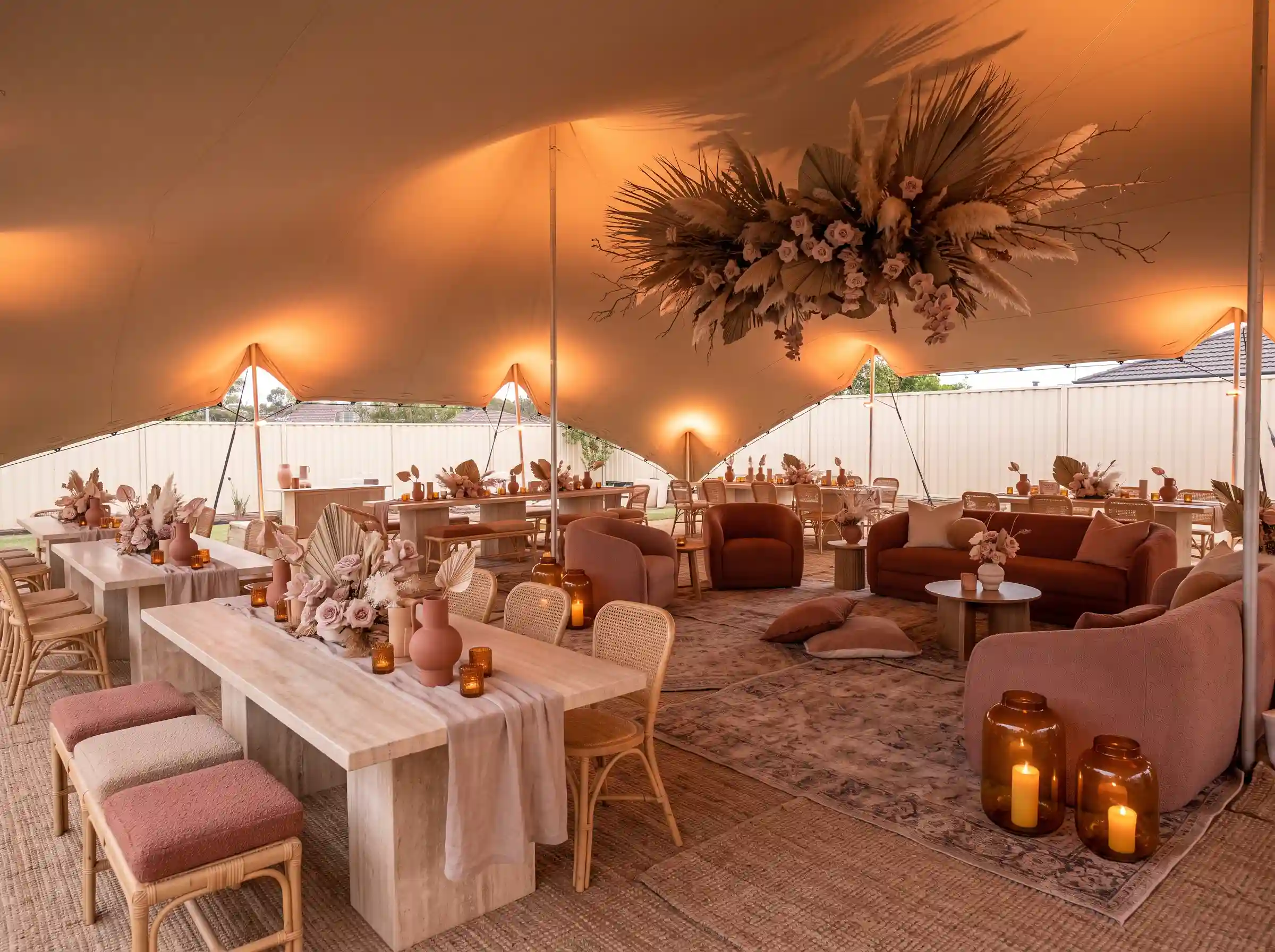 Desert rose lounge reception with pampas grass and earthy luxury under a low-profile stretch tent