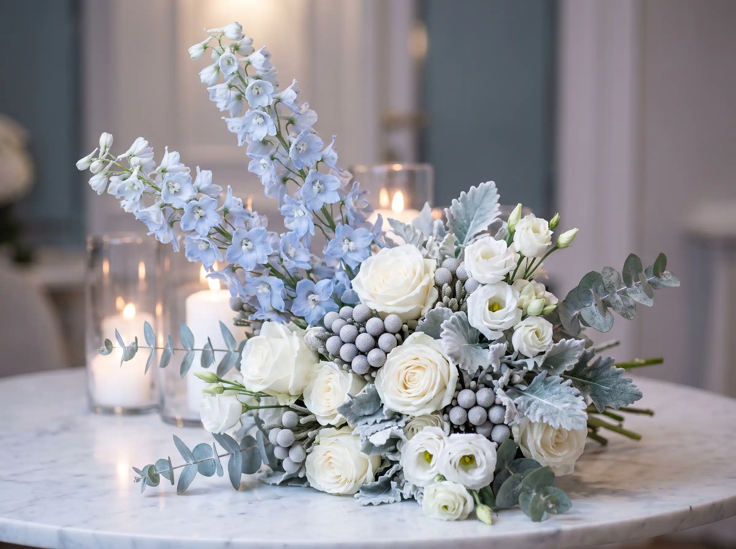 Icy blue delphinium winter wedding bouquet with white roses and silver brunia berries