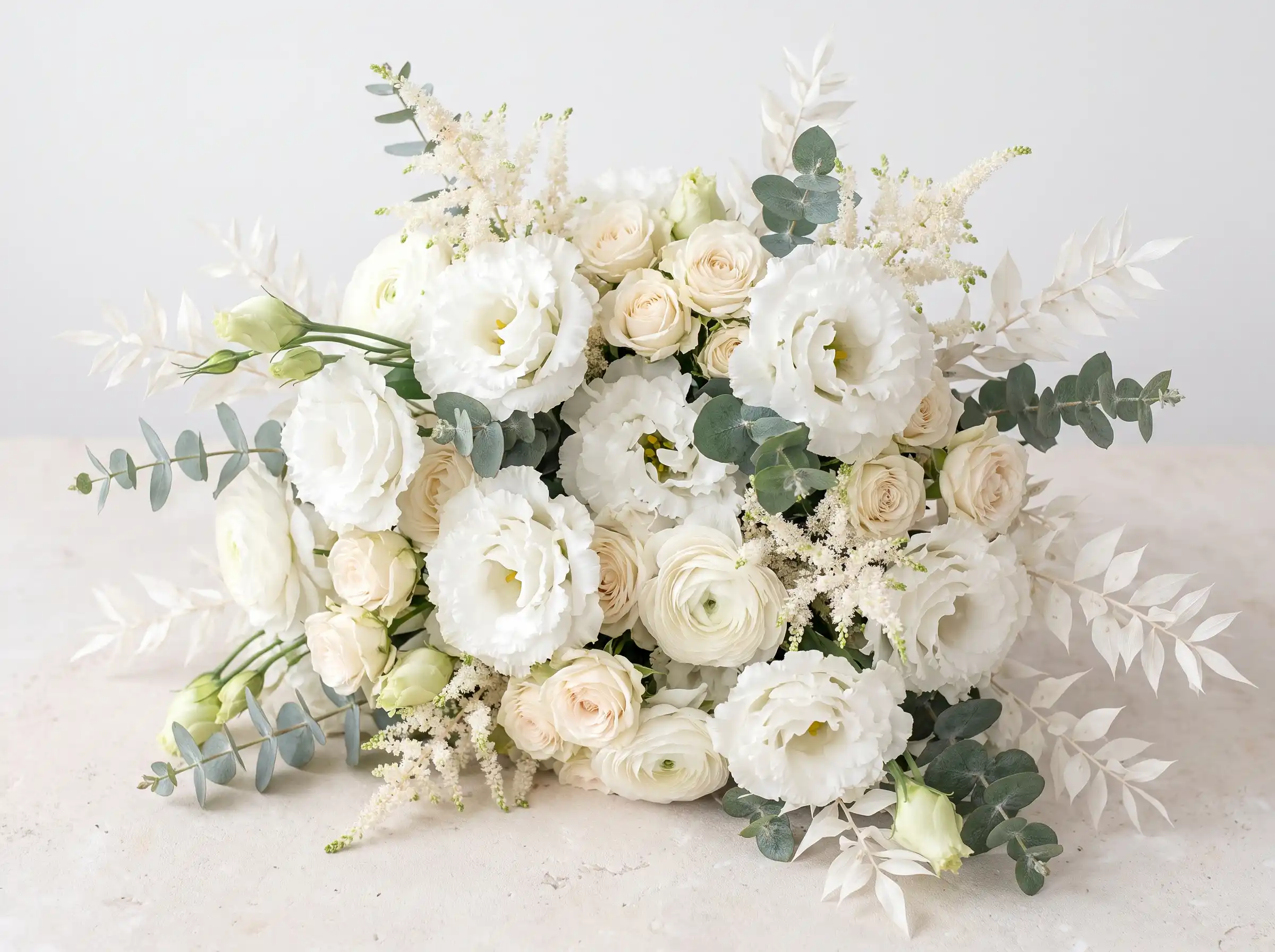 Ethereal white lisianthus cloud bouquet with spray roses ranunculus and astilbe