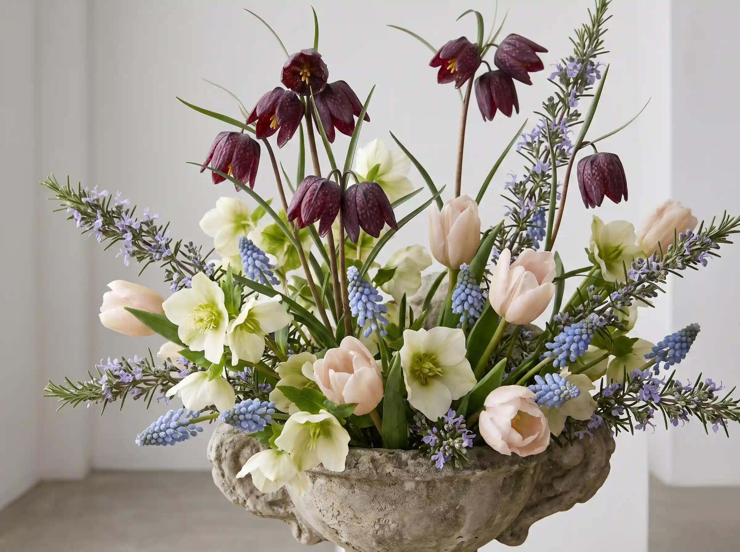 Fritillaria botanical luxe wedding arrangement with checkered plum blooms white hellebores in stone vessel