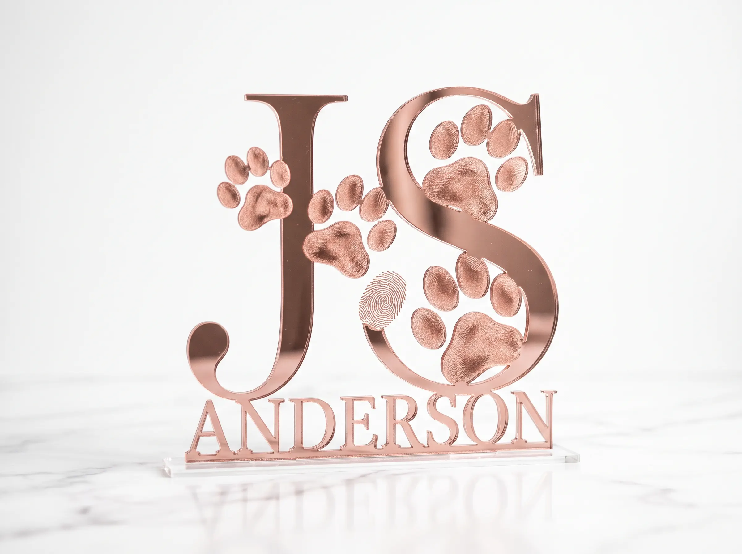 Rose gold mirror acrylic monogram cake topper with cat paw prints in letterforms