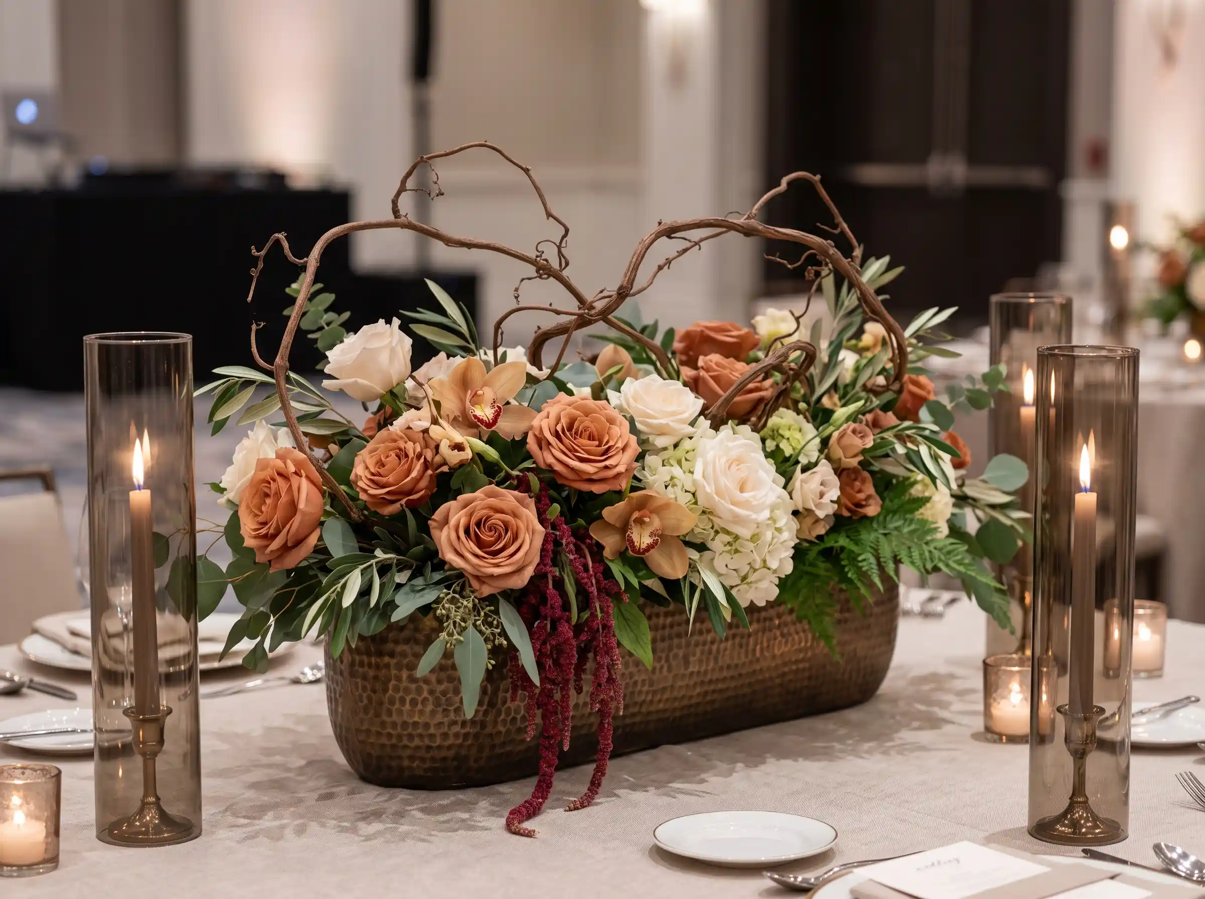 bronze accented wedding table with trailing vines and elegant floral arrangements